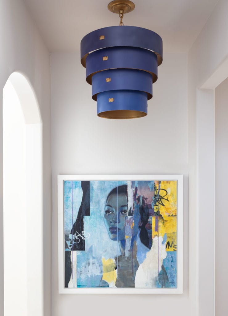 Hanging blue chandelier and a painting of a woman